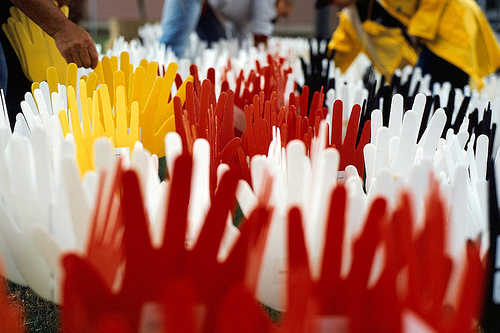 Individuals planted "sorry hands" in the soil outside the Redfern Community Centre in inner-city Sydney and a crowd watched the screening of Australian Prime Minister Kevin Rudd's formal apology to the Indigenous people of Australia.Photos by Sidat de Silva (sorry hands) and Keith Fauxtographix, Canberra (Kevin Rudd screening). Copyright Creative Commons, some rights reserved.